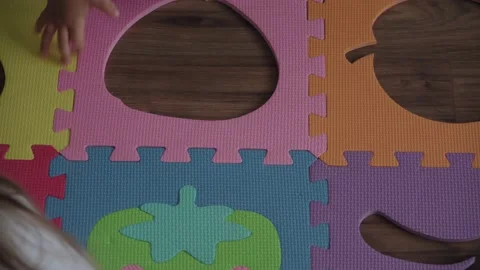 One small child boy kid collect soft puzzles fruits of big parts sit on floor Video stock 141951197