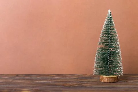 One small Christmas tree on colored background. new year decoration with copy Stock Photos
