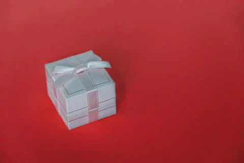 One small gift box on a red background. 스톡 사진