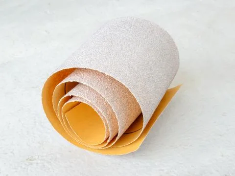 One small roll of extra coarse aluminum oxide sandpaper. Abrasive paper. Stock Photos
