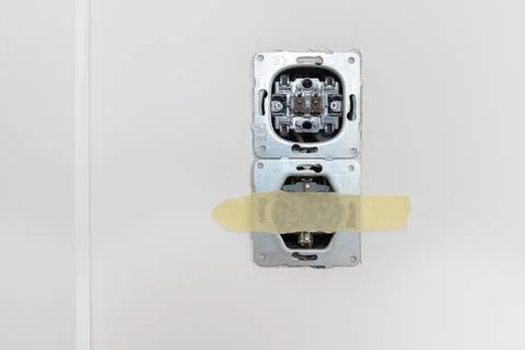 One socket and switcher of the lights installed in the white wall Stock Photos