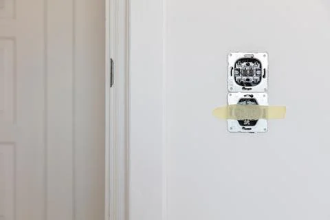 One socket and switcher of the lights installed in the white wall Stock Photos