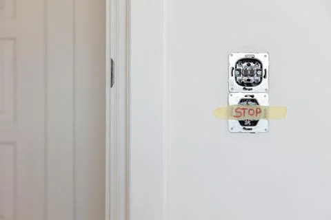 One socket and switcher of the lights installed in the white wall Stock Photos