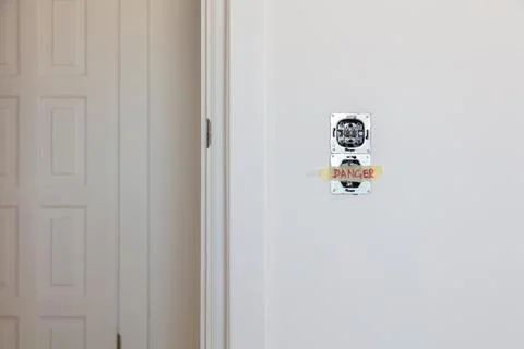 One socket and switcher of the lights installed in the white wall Stock Photos