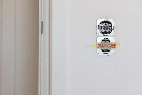 One socket and switcher of the lights installed in the white wall Stock Photos