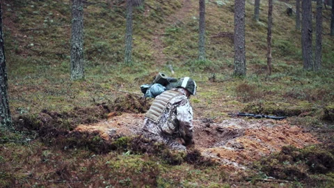 One soldier digs a trench in a pine forest. Preparing for the attack Stock Footage 194732918