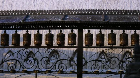 One spinning Buddhist prayer wheel among long line of prayer wheels Stock Footage 285816693