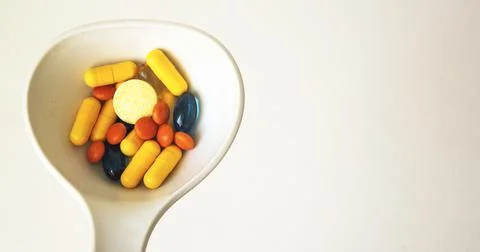 One spoon of medication in front of a White background Stock Photos