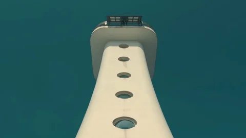 One step up the railing steps toward the white lighthouse on the beach Stock Footage 126206892