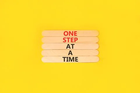 One step at a time symbol. Concept words One step at a time on beautiful wood 写真素材