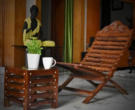 One table and one chairs from wooden boards with green home plants stands on Stock Photos