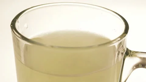 One tablet of soluble vitamin C fall into a glass of water. Stock Footage 22256076