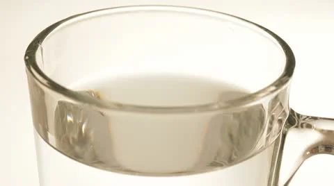 One tablet of soluble vitamin C fall into a glass of water. Stock Footage 22256085