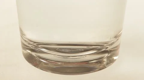 One tablet of soluble vitamin C fall into a glass of water. Video stock 22256089