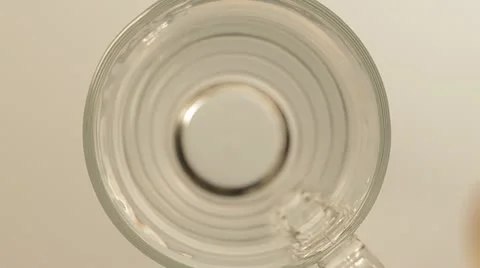 One tablet of soluble vitamin C fall into a glass of water. Stock Footage 22256154