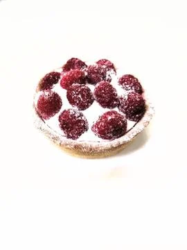 One a tartlet a raspberry cake with cream on a white plate on a white plate Stock Photos
