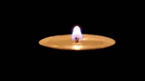 One tea candle in the dark flame sways Stock Footage 72962057