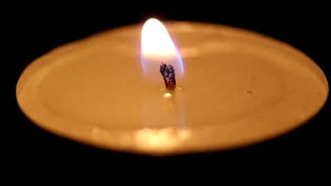 One tea candle in the dark flame sways, macro Stock Footage 72962171