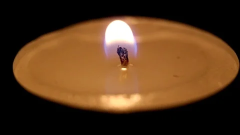 One tea candle in the dark flame sways, macro, candle goes out Stock Footage 72962244