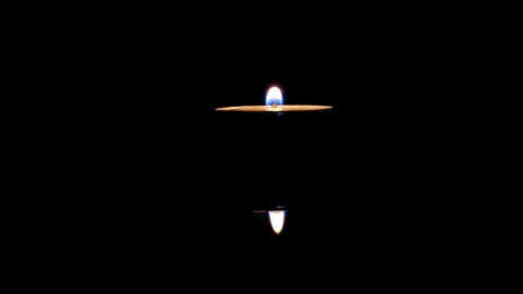 One tea candle with reflection in the dark flame sways Stock Footage 72962098