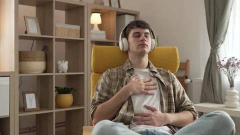 One teen man doing guided meditation yoga self care practice at home Video stock 264674976