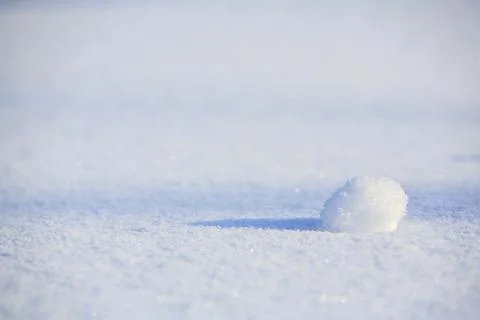 One tiny ball on snow surface at Winter, Finland 스톡 사진
