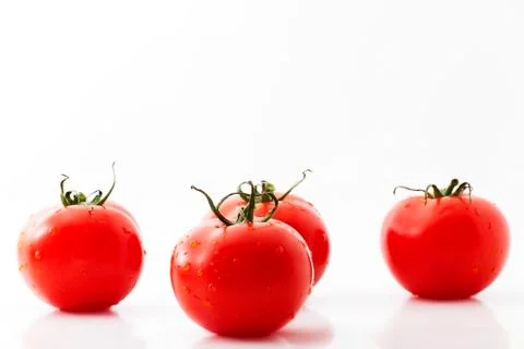 One tomato and three Stock Photos
