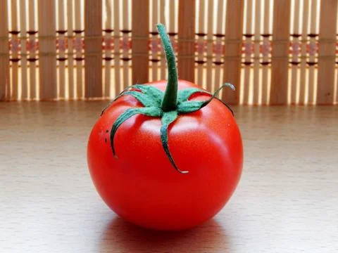 One tomato on the table close up Foto stock