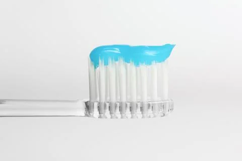 One toothbrush with toothpaste in air on white background, closeup Stock Photos