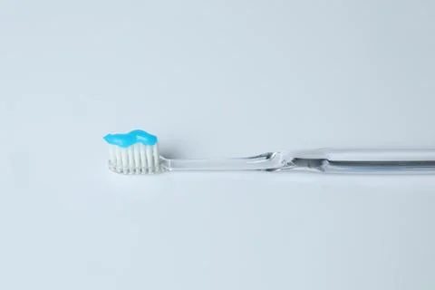 One toothbrush with toothpaste on white background Stock Photos