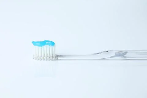 One toothbrush with toothpaste on white background Stock Photos