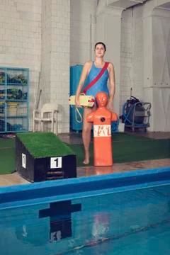 One Trainer at School Pool with Training Dummy Stock Photos
