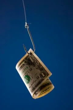 One US dollar bill on hook, against blue background Stock Photos