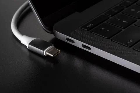 One USB type C cable disconnected from laptop Stock Photos