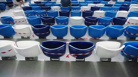 One viewer among the empty seats with a protective tape at the stadium. 스톡 동영상 140084674