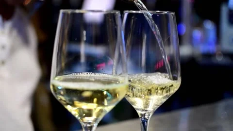 One waiter hand is serving white wine at the bar Stock Footage 133800584