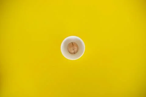 One walnut trees on a yellow solid background. Food background. Kitchen. whit Foto stock