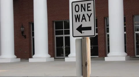 "One Way" sign in front of a building Stock Footage 53200587