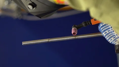 One welder make welding work, carefully scalding the chamfer made in a circle Stock Footage 126358381