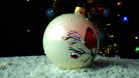 One white ball decorated with a drawing in the form of a bird on a rotating Stock Footage 166104855