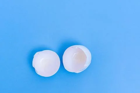 One white broken egg shell on blue background. Breaking out of the shell. egg Stock Photos