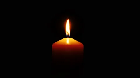 One white candle burning in front of black background, 4K. Video stock 43719261