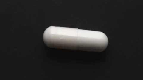 One white capsule, rotating in a circle Stock Footage
