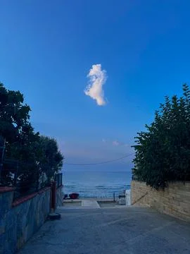 One white cloud in the blue sky on the beach Foto stock