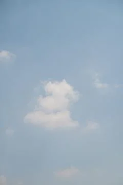One white cumulus cloud floating in the light blue sky Fotos Stock