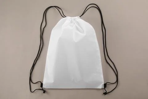 One white drawstring bag on beige background, top view Stock Photos