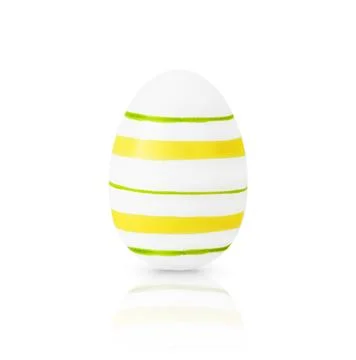 One white Easter egg decorative yellow and green stripes isolated on white ba Stock Photos