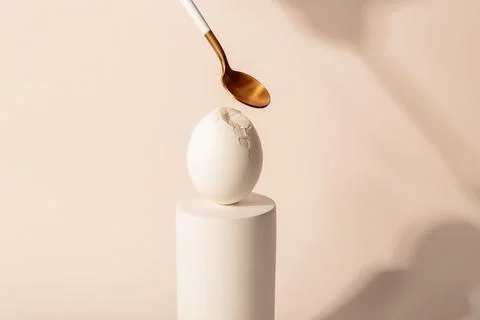 One white Easter egg on a podium against a neutral background. Minimalism and Stock Photos
