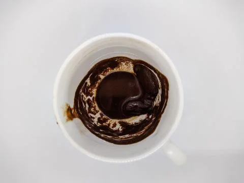 One white empty cup of custard coffee on a white background top view Stock Photos