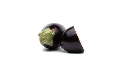 One whole and one half cut eggplant rotating on the turntable. Isolated on white Stock-Footage 157040973